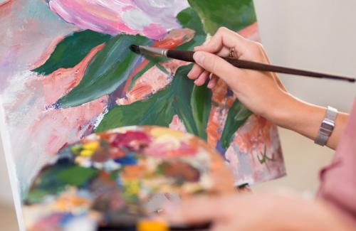 person painting a canvas for the fair 