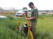 Man in tall grass doing a survey